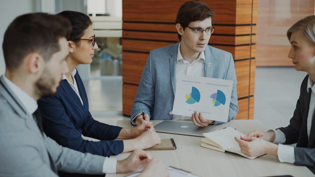 Small team of European analysts discussing data around a table